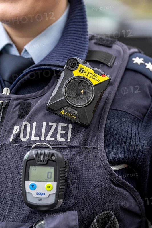 Police, policewoman with equipment waistcoat, CO measuring device device, measures the carbon monoxide content in the air during operations, e.g. in flats, the gas is odourless and has a lethal effect, above a bodycam, North Rhine-Westphalia, Germany, Europe