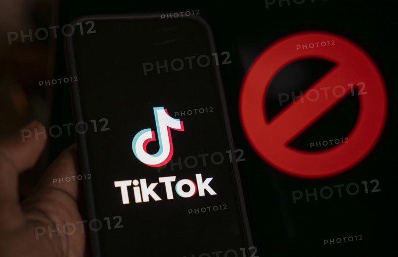 In this photo illustration, logo of Tiktok is displayed on mobile phone screen next to ban sign, in Guwahati, India 25 April 2024. US President Joe Biden signs law to ban Chinese-owned TikTok unless sold to US company
