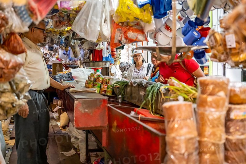Visitors at a food stall at the counter, Mercado Central de San José, San José, Costa Rica, Central America