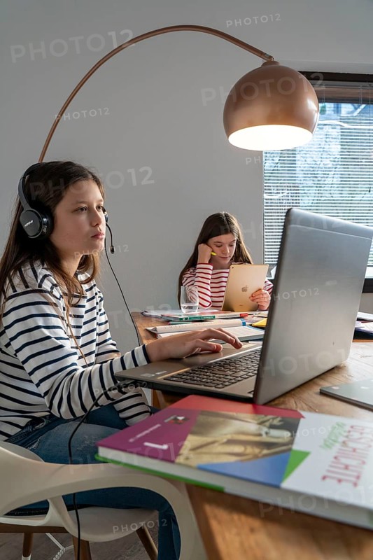Homeschooling, during the lockdown in January 2021, children learning at home for school, a girl in video lessons, video chat, with here class, a girl learning with a tablet computer, school closures, distance learning, effects of the corona crisis in Germany