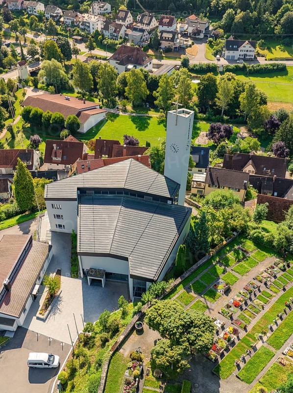 A church with a neighbouring cemetery in a green, hilly village, Gundringen, Nagold, Black Forest, Germany, Europe