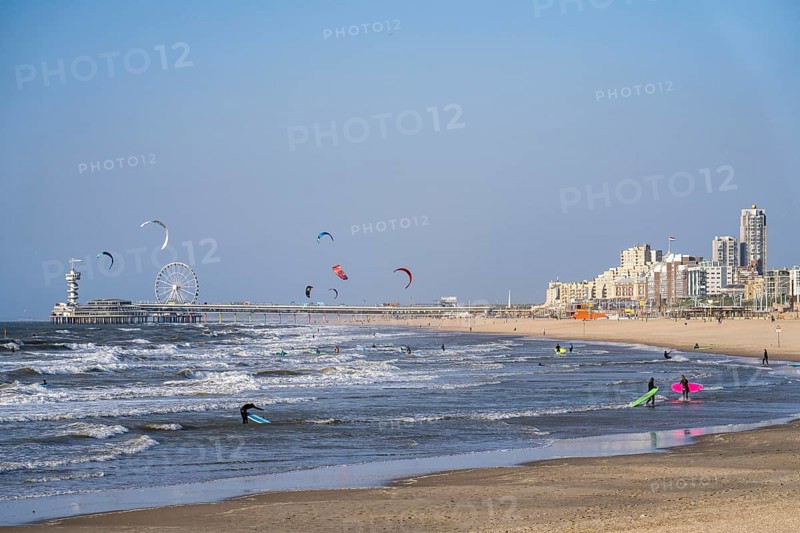 View over the beach of Scheveningen, the pier with Ferris wheel and the skyline of the town, which belongs to the city of The Hague and is the largest seaside resort in the Netherlands