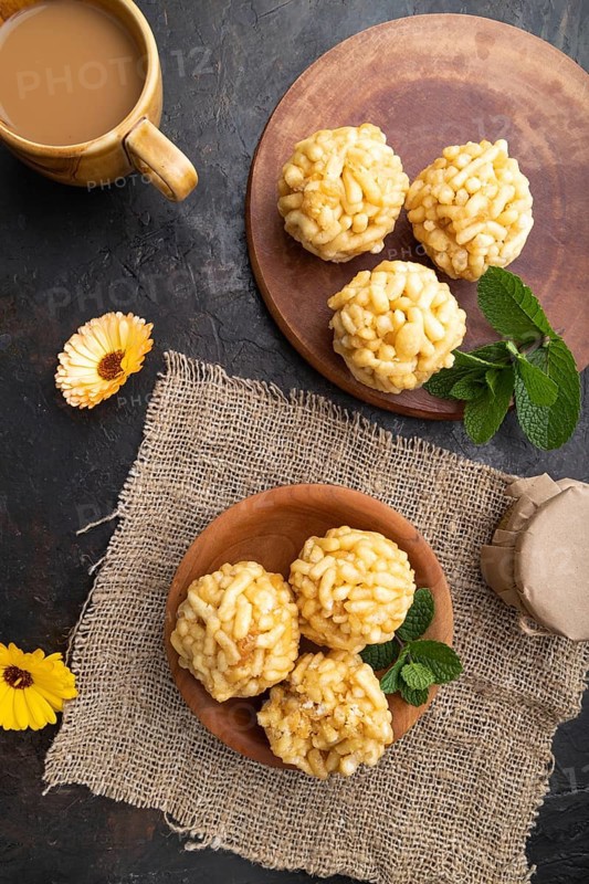 Traditional Tatar candy chak-chak made of dough and honey with cup of coffee on a black concrete background and linen textile. top view, flat lay, close up
