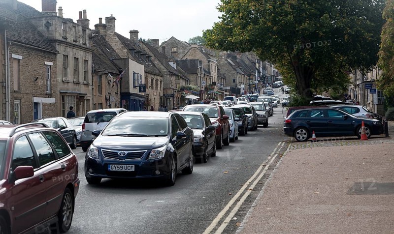 Tourist honeypot village street crowded with traffic in Burford, Oxfordshire, England, UK