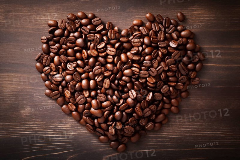 A heart shape made of rich, dark coffee beans sits atop a rustic wooden background, symbolizing a love for coffee, AI generated