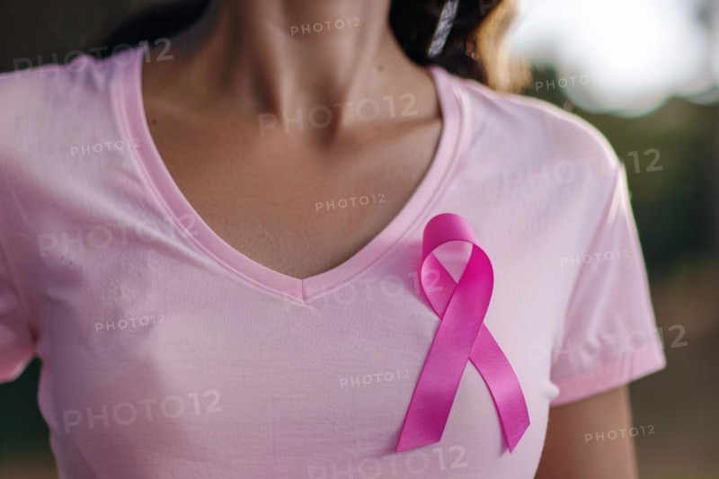 Pink breast cancer awareness ribbon attached to woman's shirt. KI generiert, generiert, AI generated