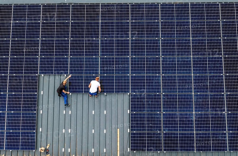 Installation of solar modules on the roof of a barn on a farm, over 210 photovoltaic modules are installed on the roof, North Rhine-Westphalia, Germany, Europe