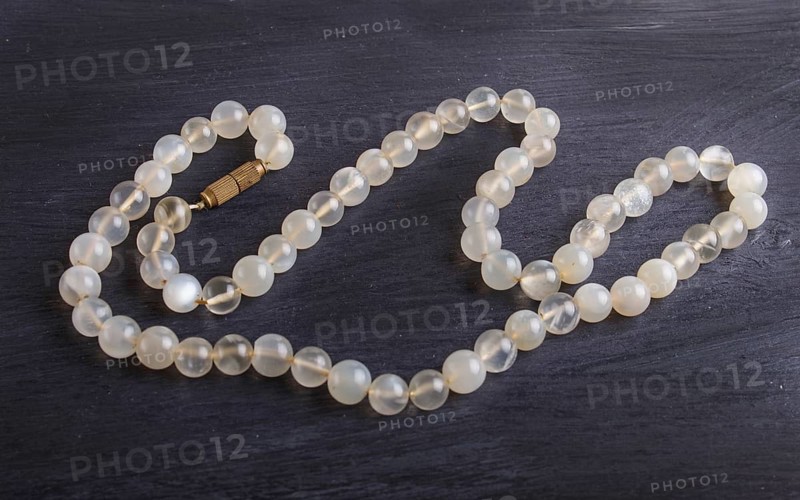 Agate colored beads on a black background. top view, close up