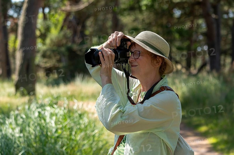 Woman taking photos, trees, circular hiking trail, Darßer Ort, Born a. Darß, Mecklenburg-Western Pomerania, Germany, Europe