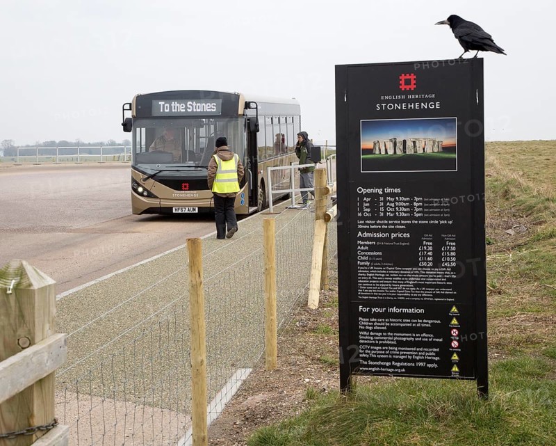 English Heritage admission prices sign and visitor bus transport to and from the Stones, Stonehenge, Wiltshire, England, UK