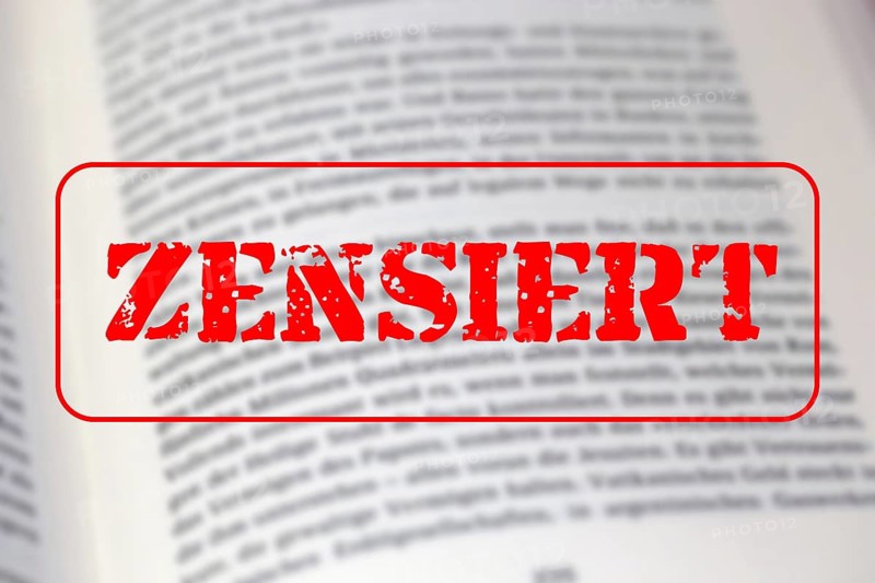 Symbolic image of the debate on the so-called cancel culture with an open book and a large red stamp