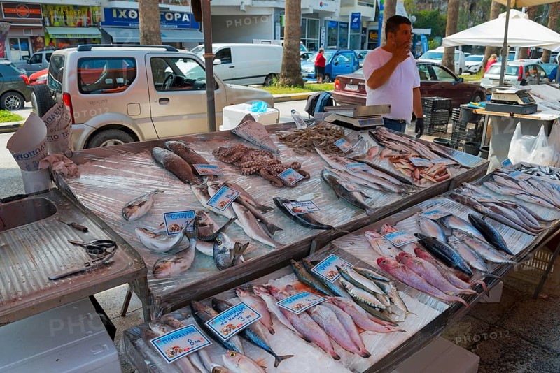 Different kinds of fish on display at a street market, city in the background, market, Nafplio, Nauplia, Nauplion, Nafplion, Argolis, Peloponnese, Greece, Europe
