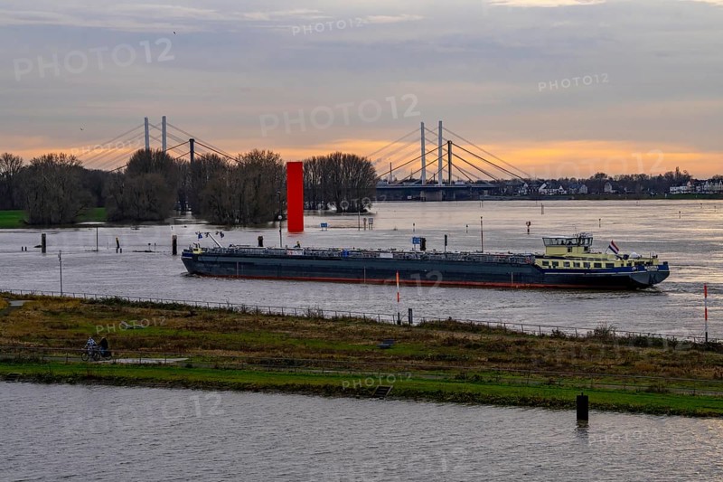 High water on the Rhine near Duisburg, freighter enters the harbour canal, Neuenkamp Rhine bridge, old and new construction, landmark Rhine orange, washed over by high water, North Rhine-Westphalia, Germany, Europe