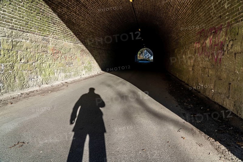 Shadow of a person, man, at the beginning of a tunnel, symbolic image