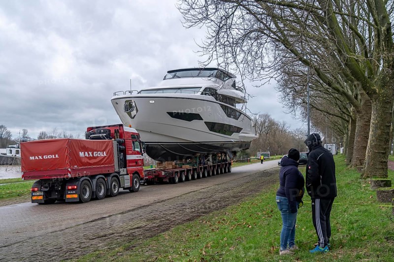 Craning the €6.3 million Sunseeker 88Y motor yacht, weighing 82 tonnes, in preparation for the world's largest water sports trade fair, Boot in Düsseldorf, luxury yachts are driven across the Rhine to the trade fair and brought ashore with the help of the Big Willi ship crane and transported to the exhibition halls on a low-loader, North Rhine-Westphalia, Germany, Europe