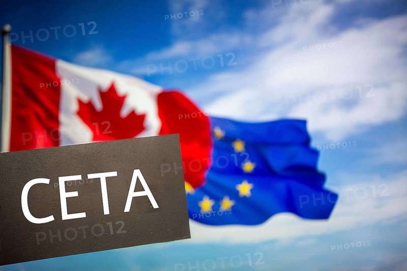 Sign reading CETA in front of the flags of Canada and the European Union. The abbreviation CETA stands for a free trade agreement between the two partners