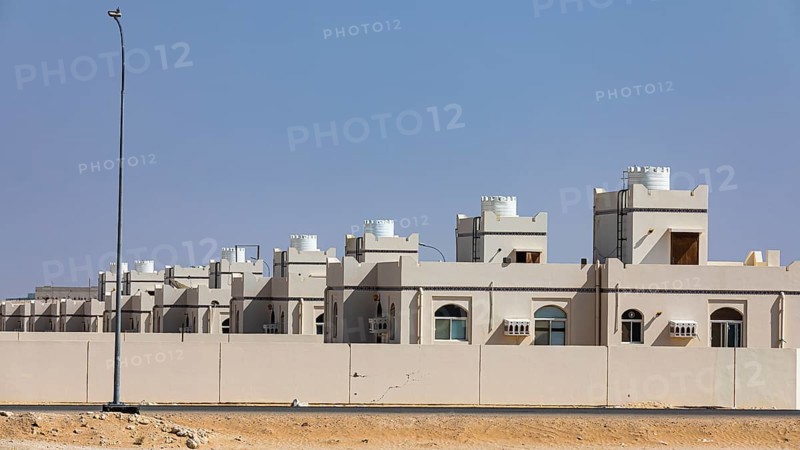 Modern terraced housing estate in the village of Maqshin, on Mascat-Salalah Road, Dhofar Province, Arabian Peninsula, Sultanate of Oman