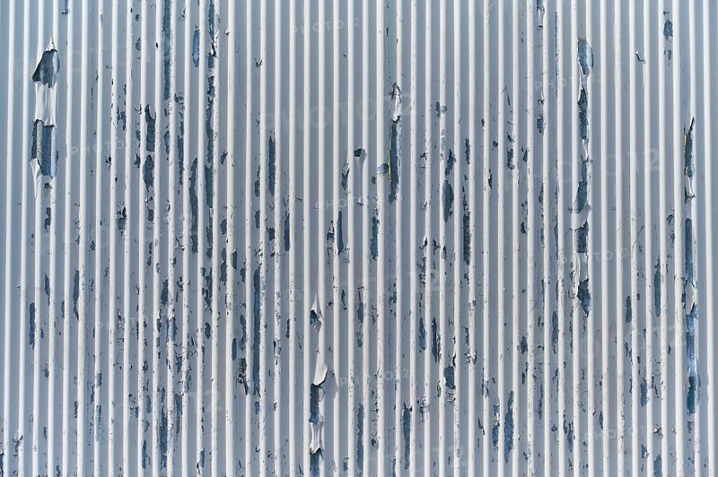 Weathered metal wall with peeling paint, showing industrial texture and vertical lines, Sandnes, Fylke Rogaland, Norway, Europe