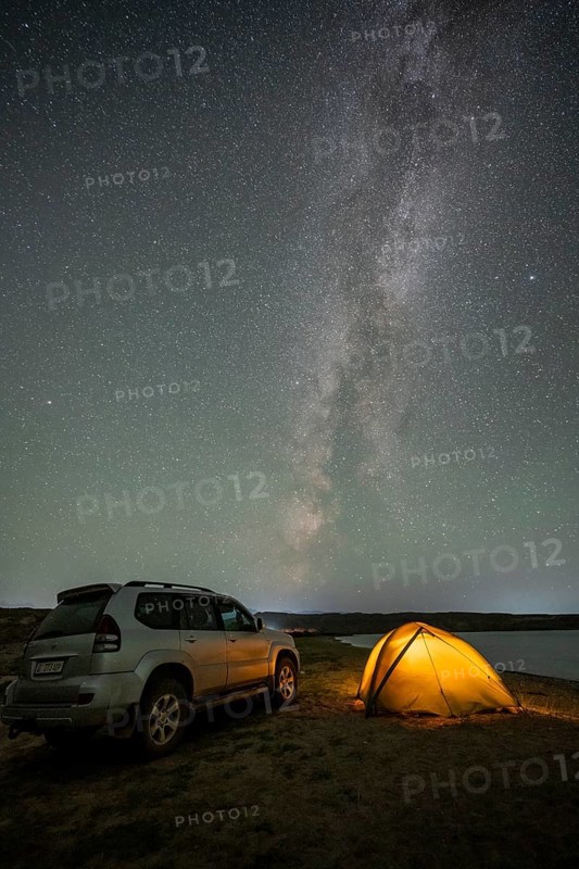 Off-road vehicle and tent, night shot, Milky Way at Lake Issyk Kul, Kyrgyzstan, Asia