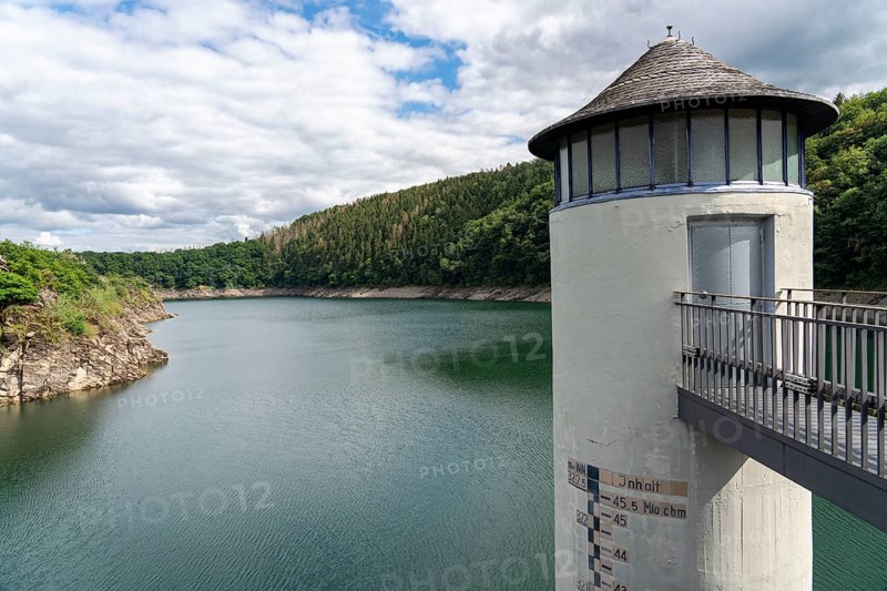 The dam wall of the Urft dam, Grundablassturm, merges into the Rursee, Eifel National Park, North Rhine-Westphalia, Germany, Europe