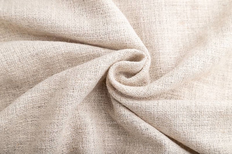 Fragment of white linen tissue. Side view, natural textile background and texture. wave concept, abstract, spiral form