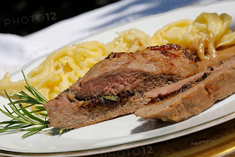 Swabian cuisine, lamb stuffed with prunes, rosemary, herbs, fillets arranged on plates, hand-scraped spaetzle, gravy, grandmother's cooking, regional, home cooking, typical Swabian, traditional cuisine reinterpreted, food photography, studio, Germany, Europe