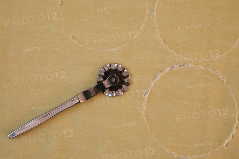 Swabian cuisine, preparation of salmon ravioli, cutting raw pasta dough with a pastry wheel, salmon in pasta dough, Swabian ravioli, typical Swabian cuisine, traditional cuisine reinterpreted, food photography, studio, Germany, Europe