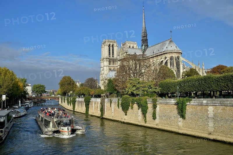 Sightseeing boat on the Seine river in front of Notre Dame Cathedral, Paris, France, Europe