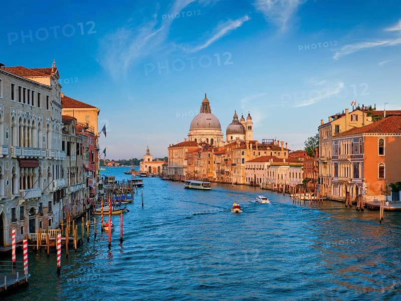 Panorama of Venice Grand Canal with boats and Santa Maria della Salute church on sunset from Ponte dell'Accademia bridge. Venice, Italy, Europe