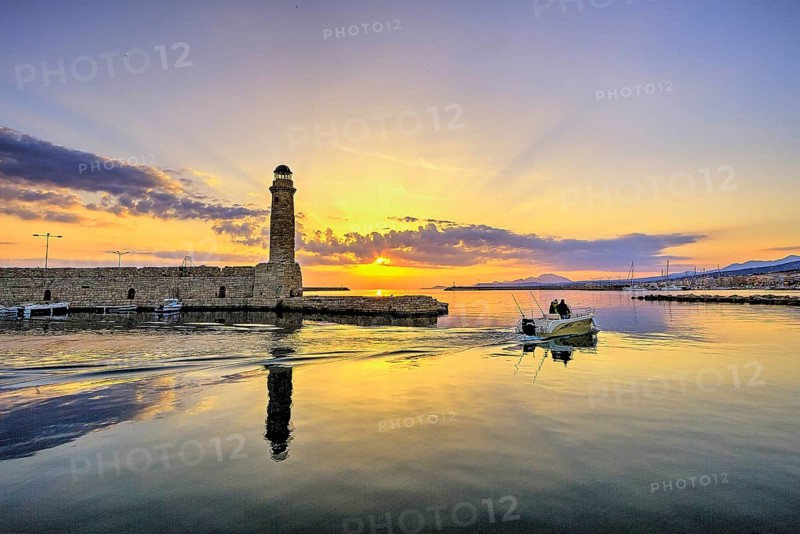 Morning light, sunrise, Venetian harbour, Venetian lighthouse, back light, HDR, boat leaving harbour, blue and orange sky, few grey clouds, Rethimnon, central Crete, island of Crete, Greece, Europe