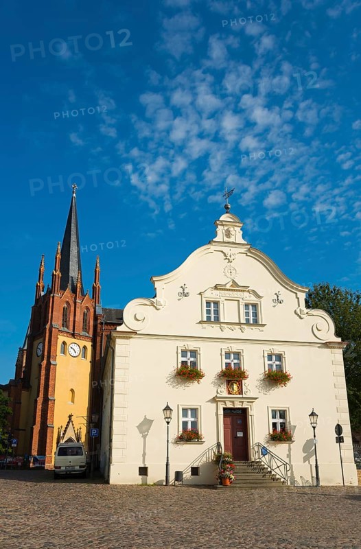 Historic church tower next to a baroque building in sunny weather with blue sky, Heilig-Geist-Kirche and town hall, old town island of Werder in der Havel, Potsdam-Mittelmark, Brandenburg, Germany, Europe