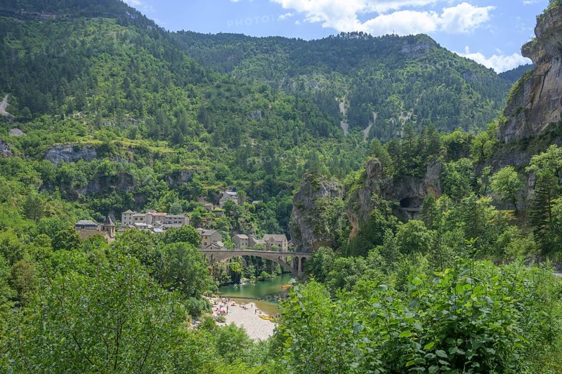 View of the village of Saint Chely with bridge and waterfall, Gorges du Tarn Causses, Département Lozère, France, Europe