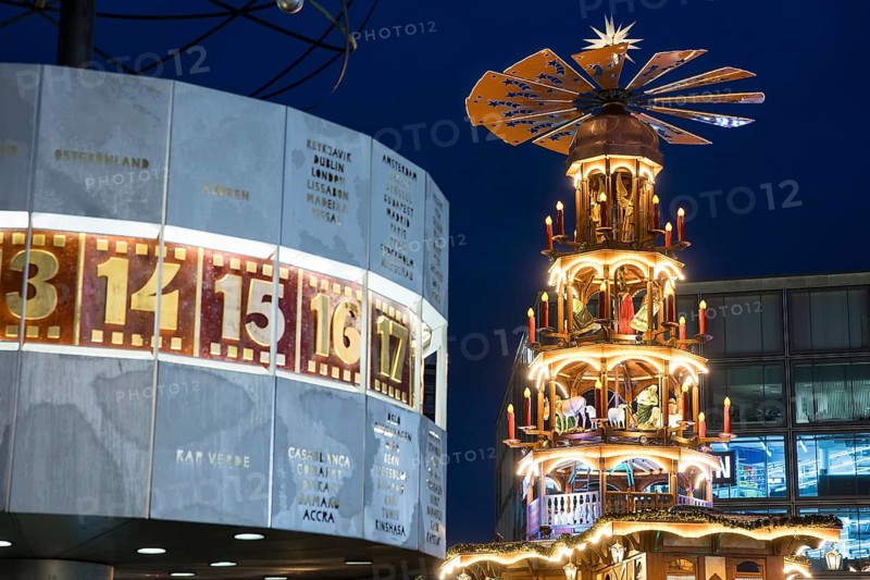 A Christmas pyramid behind the World Time Clock at the Christmas market on Alexanderplatz, Berlin, 21.12.2024