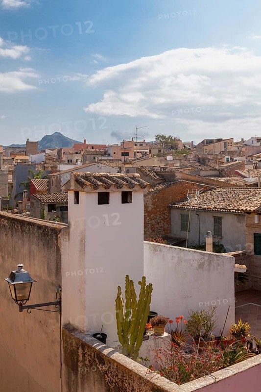 Mediterranean village with stone houses and green terraces under a slightly cloudy sky, Alcudia, Majorca, Balearic Islands, Spain, Europe