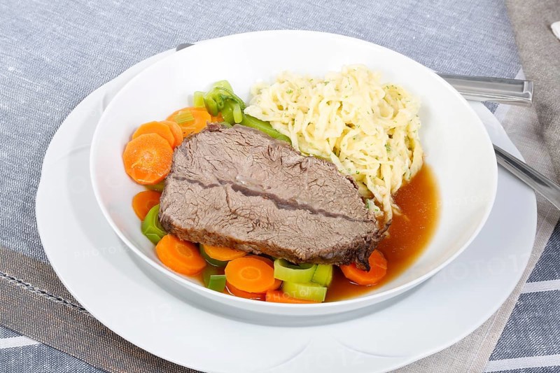 Swabian cuisine, roast beef, roast ox, herb spaetzle, meat dish, gravy, carrot vegetables, leek, plate, hearty, savoury, typical Swabian, home cooking, traditional cuisine, food photography, studio, Germany, Europe