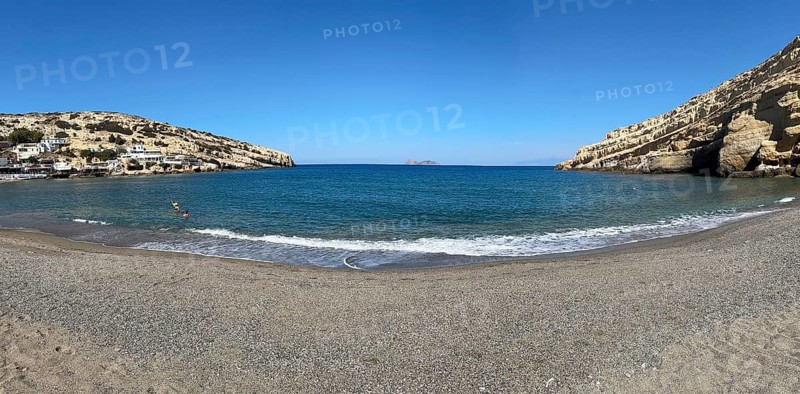 Panoramic photo of Matala bay front beach without beach chairs sunshades, Matala, Crete, Greece, Europe