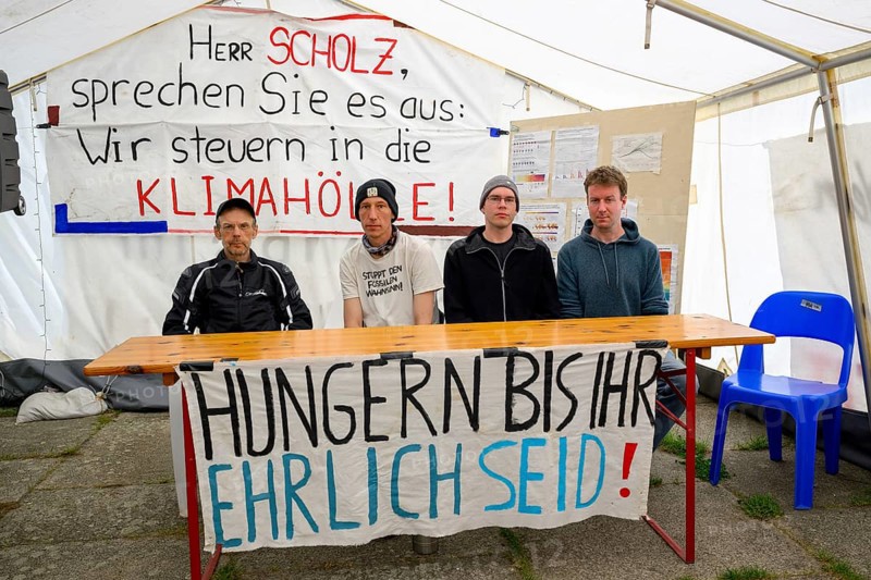 The hunger strikers of Hunger until you are honest after the press conference, from left to right: Richard Cluse, Wolfgang Metzeler-Kick, Adrian Lack (on silent hunger strike), Titus Feldmann, hunger strike camp, Invalidenpark, Berlin, 23 May 2024
