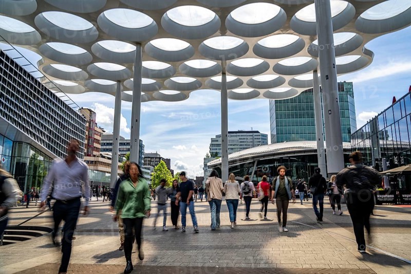 Station forecourt of Utrecht Centraal station, people on their way to and from the station, Hoog Catharijne shopping centre, Netherlands