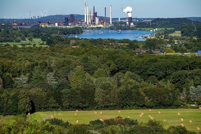 View across the Rhine to the Thyssenkrupp Steel steelworks in Duisburg-Beeckerwerth, blast furnaces, coking plant, green landscape on the left bank of the Rhine, North Rhine-Westphalia, Germany, Europe