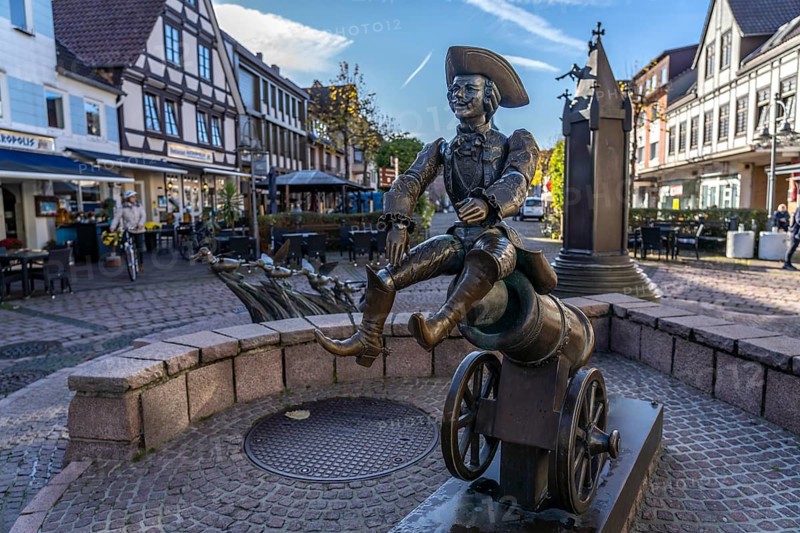 Munchausen figure The ride on the cannonball at the Munchausen fountain in Bodenwerder, Lower Saxony, Germany, Europe