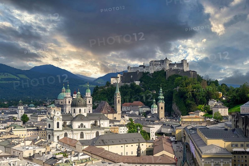 Panorama of Salzburg's historic city centre at dusk with Hohensalzburg Fortress and dramatic clouds, Salzburg, Salzburger Land, Austria, Europe