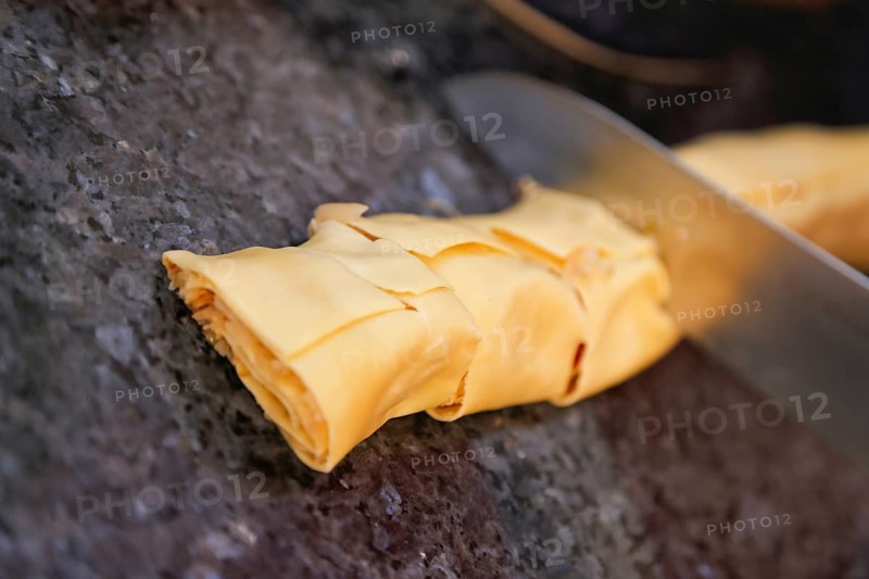 Swabian cuisine, preparation of cabbage fritters, Swabian flour sacks, stuffed pasta pancakes with sauerkraut and smoked meat, savoury, salty, main course, raw pasta pancakes, grandmother's kitchen, regional, home cooking, typical Swabian, traditional cuisine reinterpreted, knife, food photography, studio, Germany, Europe