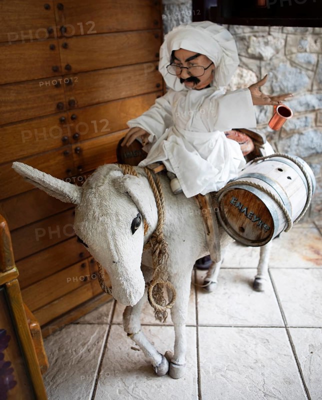 Cloth donkey carrying a male doll and wine barrels, mountain village Langadia, Arcadia, Peloponnese, Greece, Europe