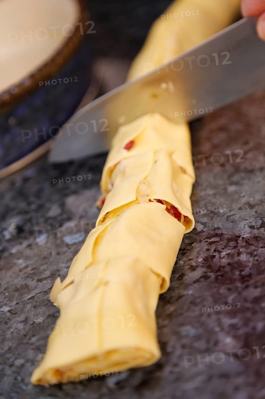 Swabian cuisine, preparation of cabbage fritters, Swabian flour sacks, stuffed pasta pancakes with sauerkraut and smoked meat, savoury, salty, main course, raw pasta pancakes, grandmother's kitchen, regional, home cooking, typical Swabian, traditional cuisine reinterpreted, knife, food photography, studio, Germany, Europe