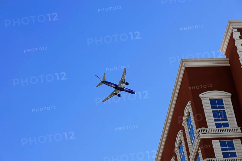 Las Vegas, Nevada, USA, North America, aeroplane in the clear blue sky, next to a large multi-storey building, Las Vegas Strip, North America
