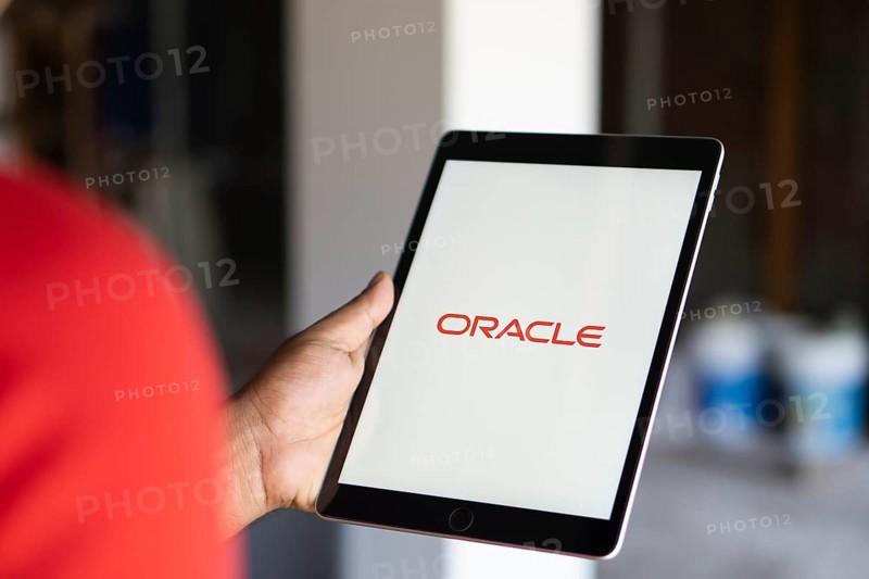 ORACLE logo displayed on smartphone screen. ORACLE is a multinational computer technology corporation