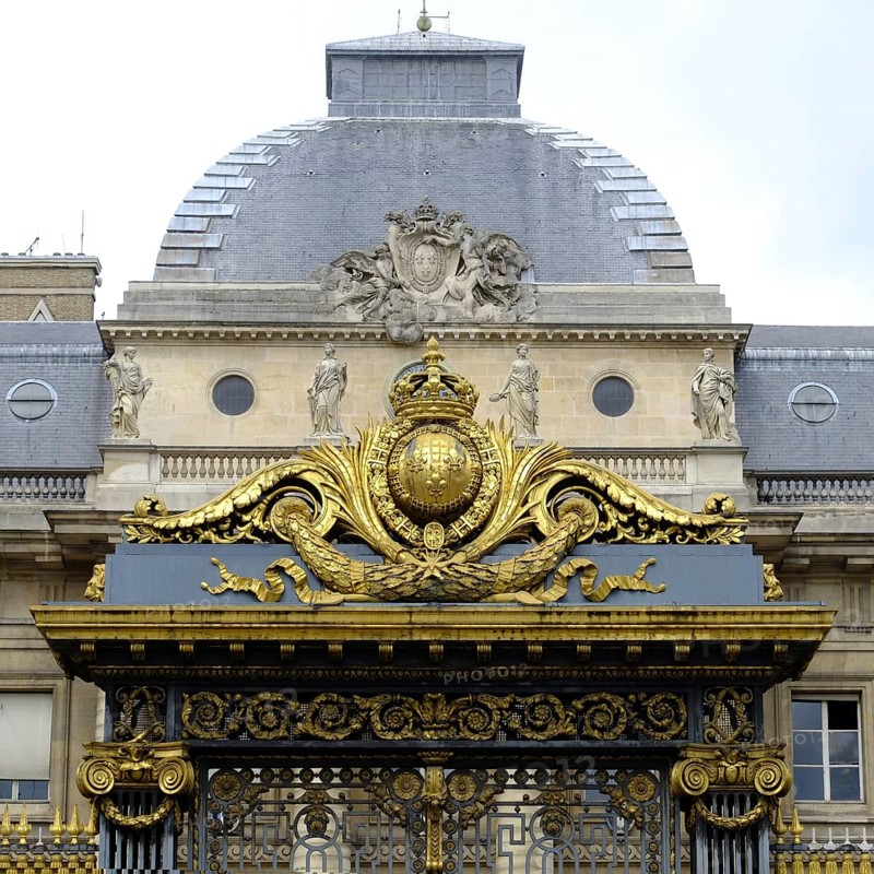 The wrought-iron, richly decorated portal of the Palais de Justice in Paris. Square format. The richly decorated wrought-iron portal of the Palais de Justice