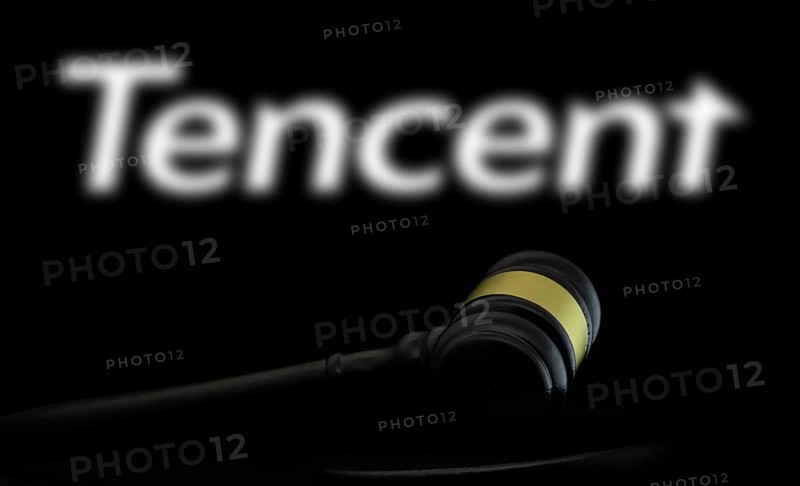 Court gavel in front of the Tencent logo. Tencent Holdings Ltd is a Chinese multinational technology conglomerate and holding company.