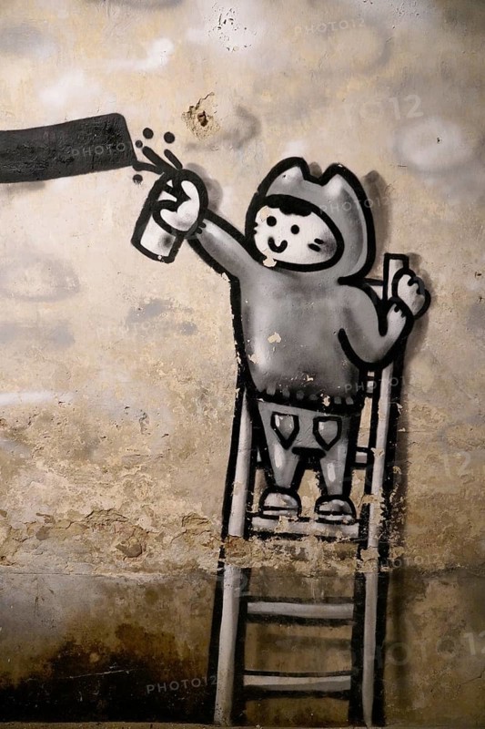 MAUSA VAUBAN, Museum of Urban Art and Street Art, Neuf-Brisach Fortress, France, Europe, A mural shows a child on a ladder painting graffiti with a spray can, Europe