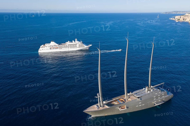 Aerial view 143 metre long three-master Sailing Yacht A, largest sailing yacht in the world, built to a design by designer Philippe Starck by the German shipyard Nobiskrug and delivered in 2017 to the Russian oligarch Andrei Melnichenko, Andrey Melnichenko, over 100 metre high carbon masts, at anchor in the morning off the Principality of Monaco, Cote d'Azur, Mediterranean Sea